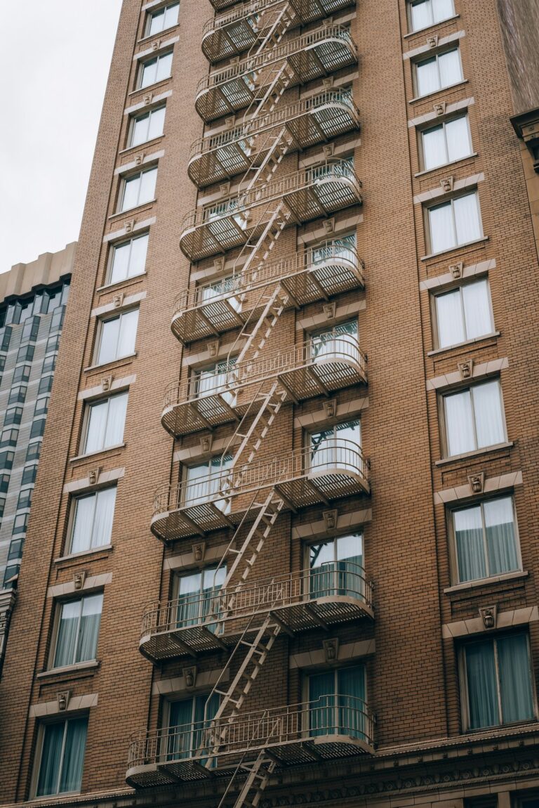 A maintenance technician checks an HVAC system on the rooftop of a commercial building.